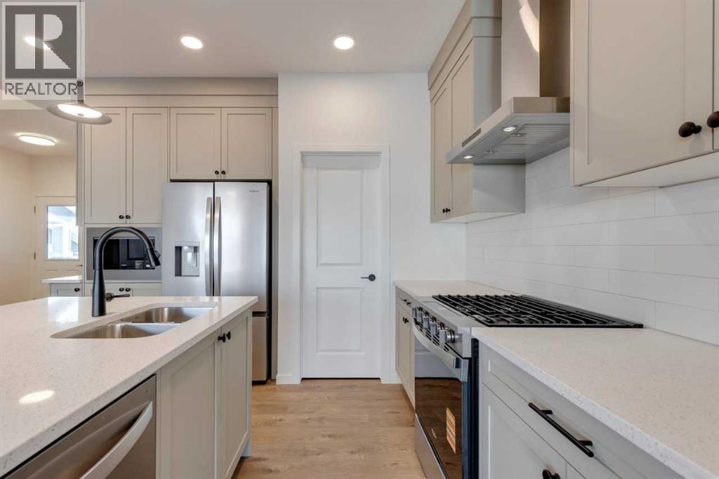 1379 Bayview Crescent Sw, Airdrie, AB - Indoor Photo Showing Kitchen With Double Sink With Upgraded Kitchen