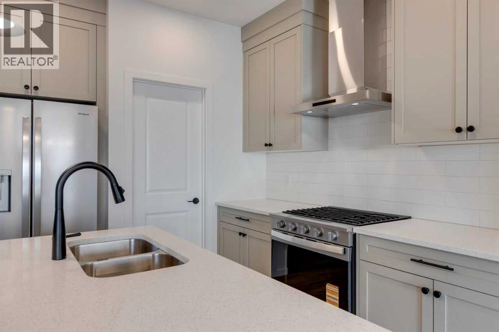 1379 Bayview Crescent Sw, Airdrie, AB - Indoor Photo Showing Kitchen With Double Sink With Upgraded Kitchen
