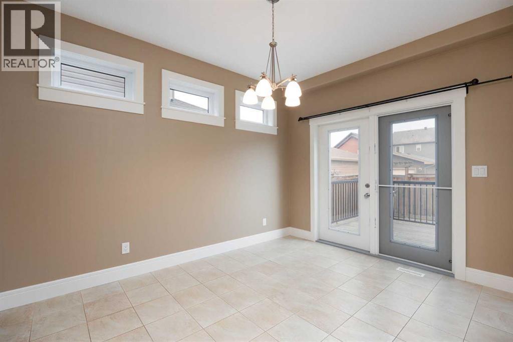 Dining room with entrance to back deck - 197 Snowy Owl Way Nw, Fort Mcmurray, AB - Indoor Photo Showing Other Room