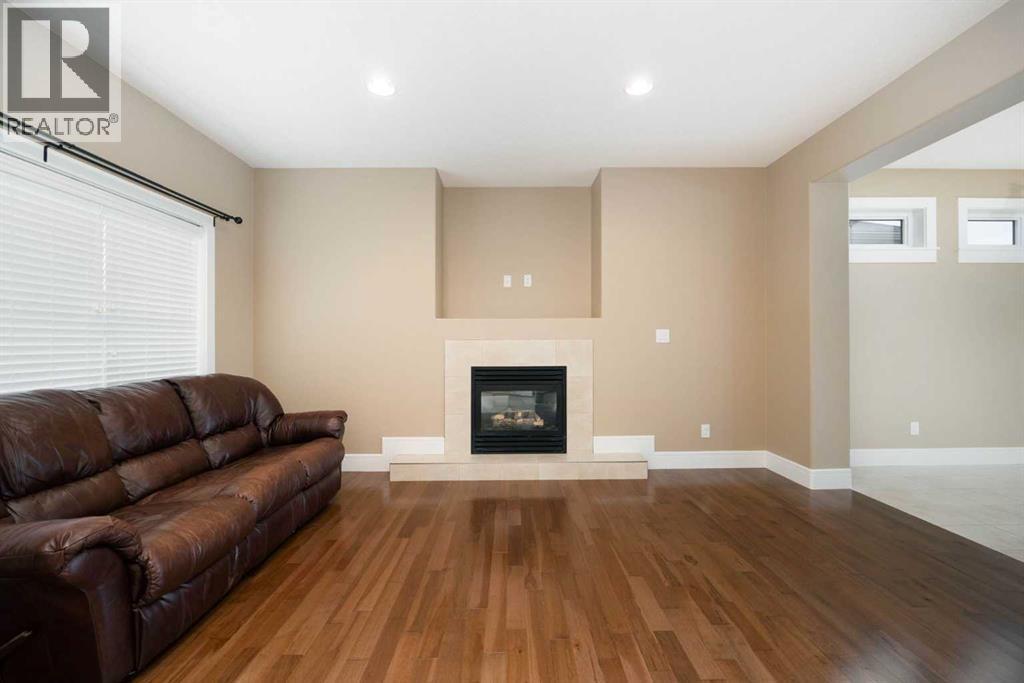 Living room with gas fireplace - 197 Snowy Owl Way Nw, Fort Mcmurray, AB - Indoor Photo Showing Living Room With Fireplace