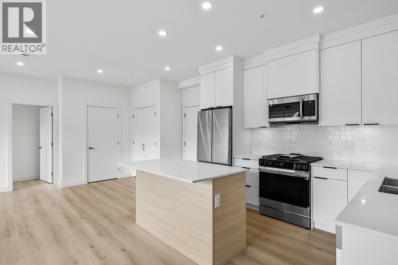 Photos may be of a similar home in the community - 5300 Main Street Unit# 202, Kelowna, BC - Indoor Photo Showing Kitchen With Upgraded Kitchen