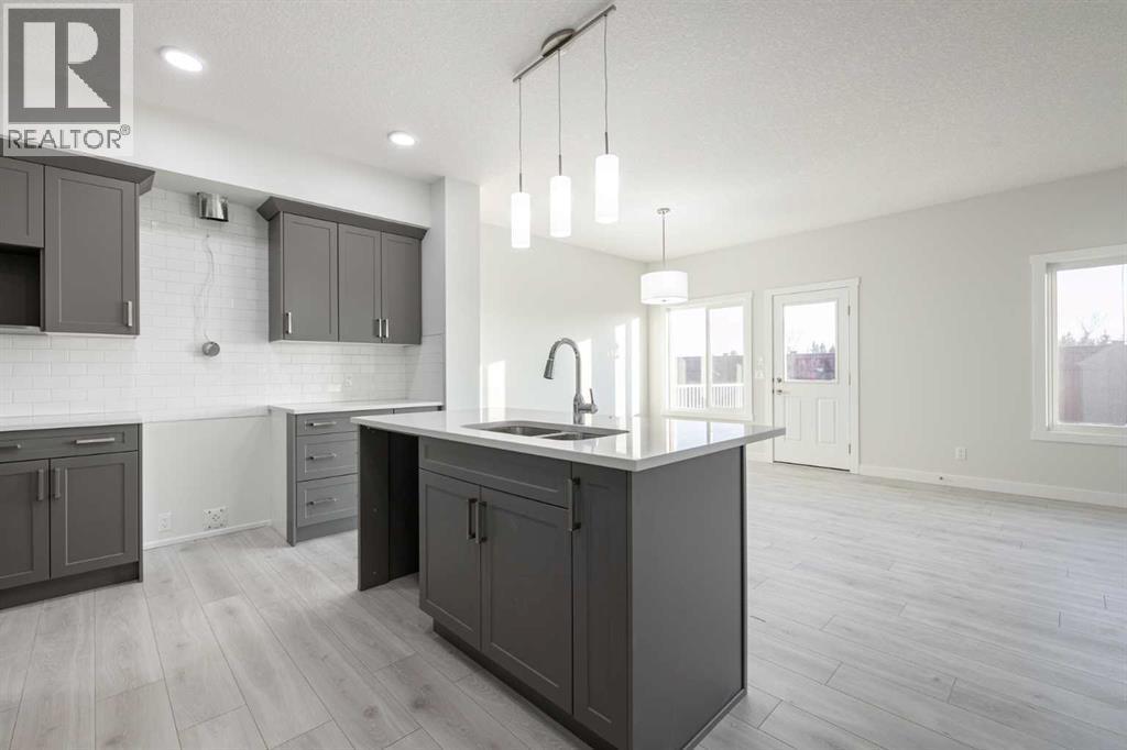 17 Sora Gardens Se, Calgary, AB - Indoor Photo Showing Kitchen With Double Sink With Upgraded Kitchen