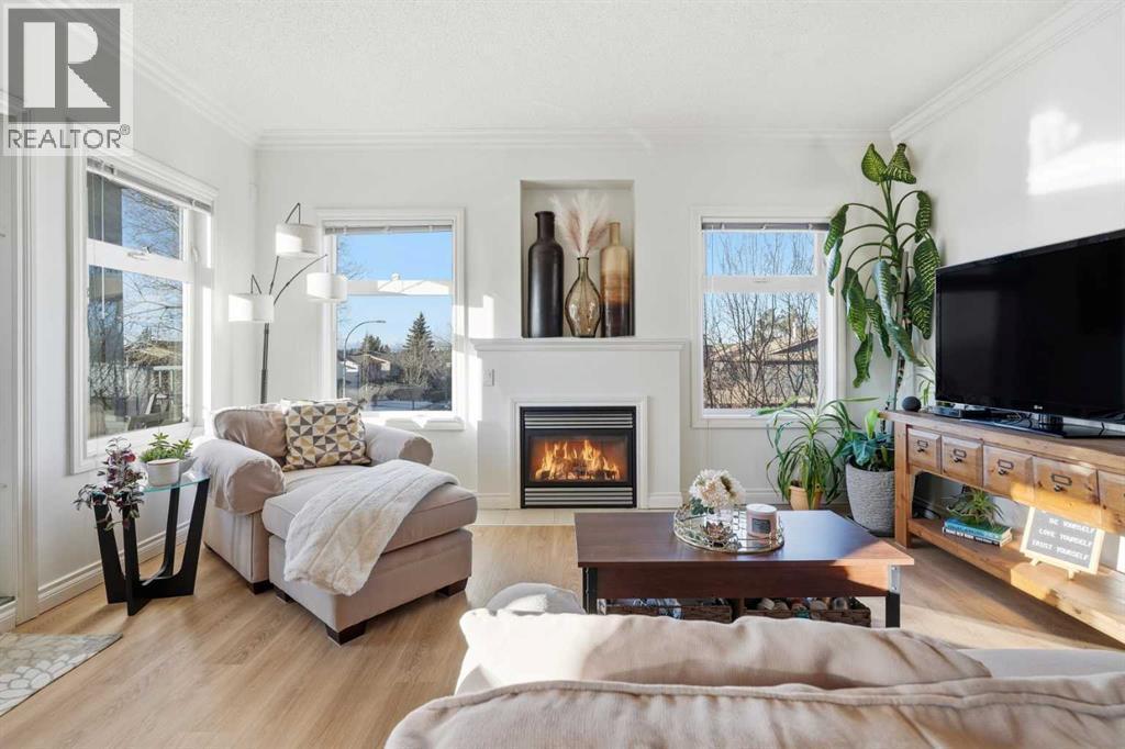 203, 11170 30 Street Sw, Calgary, AB - Indoor Photo Showing Living Room With Fireplace