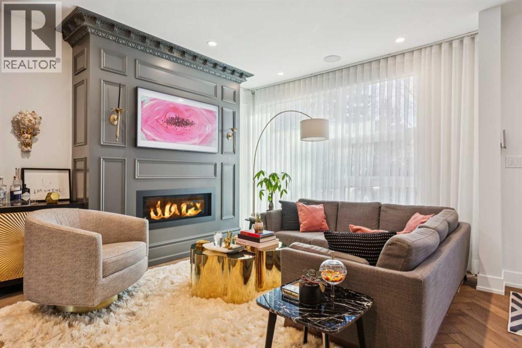 CUSTOM FIREPLACE, HERRINGBONE HARDWOOD FLOORS AND CUSTOM SHEERS - 3813 1A Street Sw, Calgary, AB - Indoor Photo Showing Living Room With Fireplace