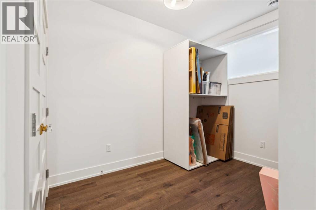 BEDROOM $4 WITH LARGE WINDOW. STORAGE RACKS CAN BE REMOVED - 3813 1A Street Sw, Calgary, AB - Indoor Photo Showing Other Room