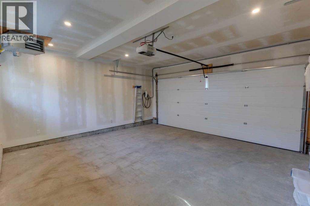 HEATED AND FINISHED DOUBLE GARAGE WITH 2 EV CHARGERS - 3813 1A Street Sw, Calgary, AB - Indoor Photo Showing Garage