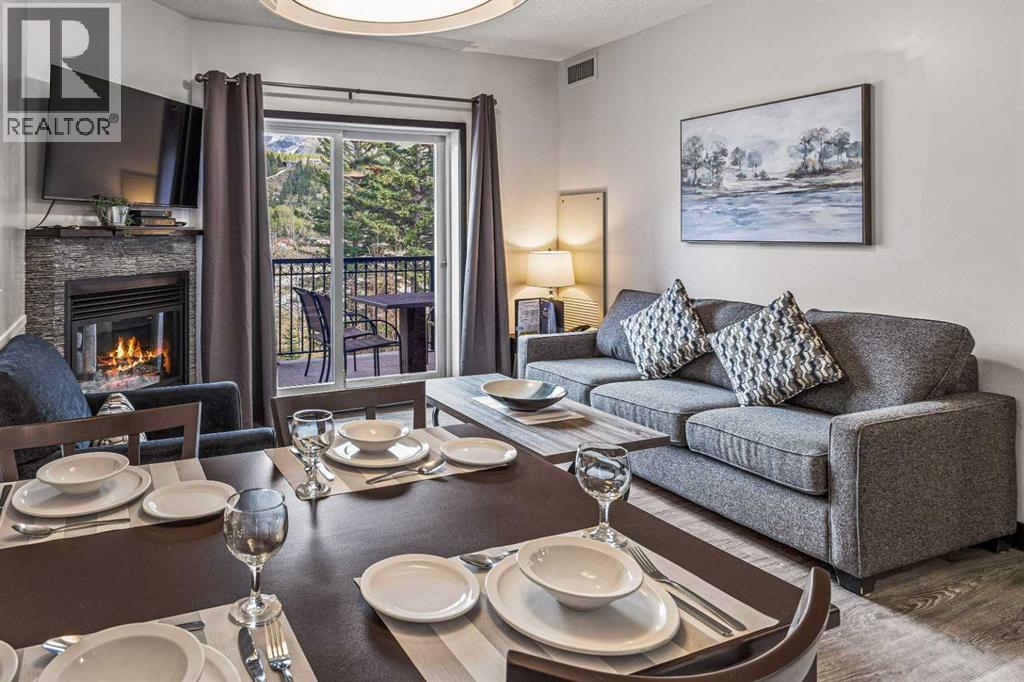 326 Rot. Ef, 901 Mountain Street, Canmore, AB - Indoor Photo Showing Living Room With Fireplace