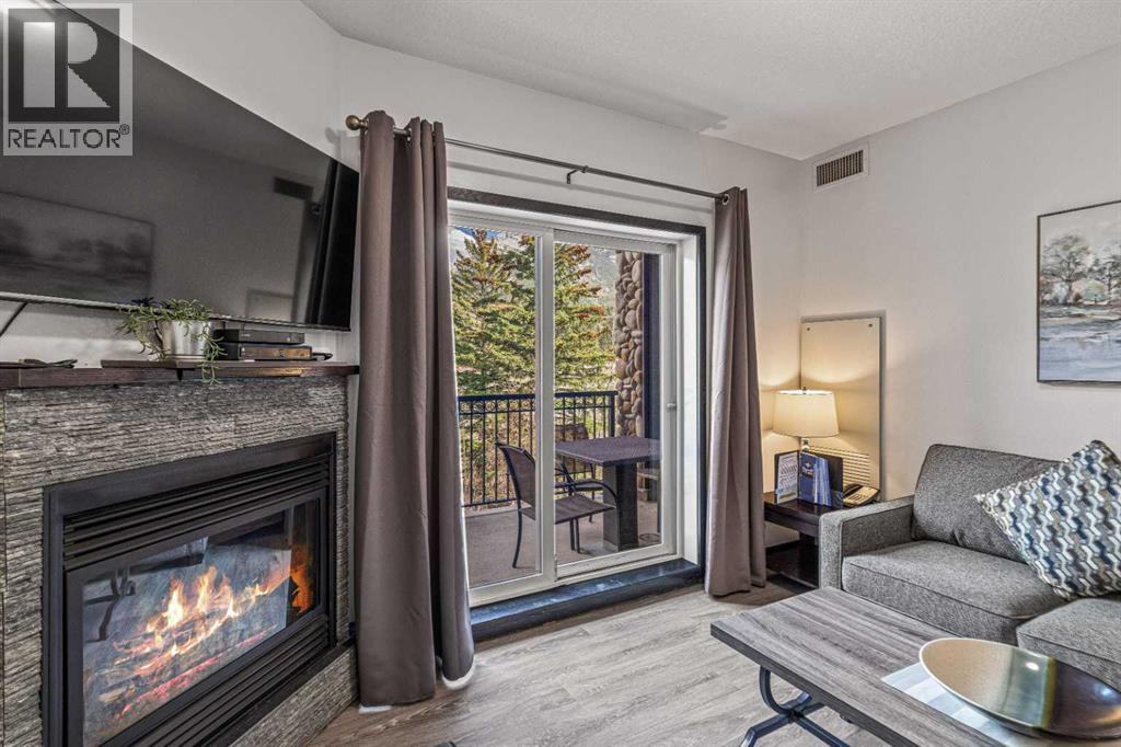 326 Rot. Ef, 901 Mountain Street, Canmore, AB - Indoor Photo Showing Living Room With Fireplace