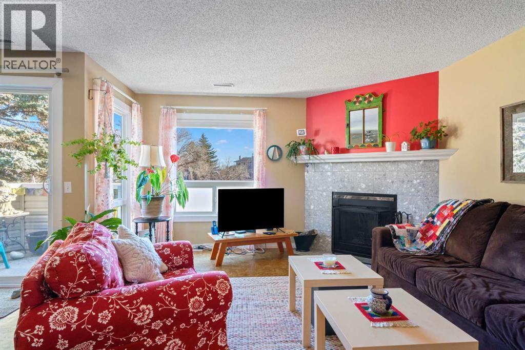 43, 200 Shawnessy Drive Sw, Calgary, AB - Indoor Photo Showing Living Room With Fireplace