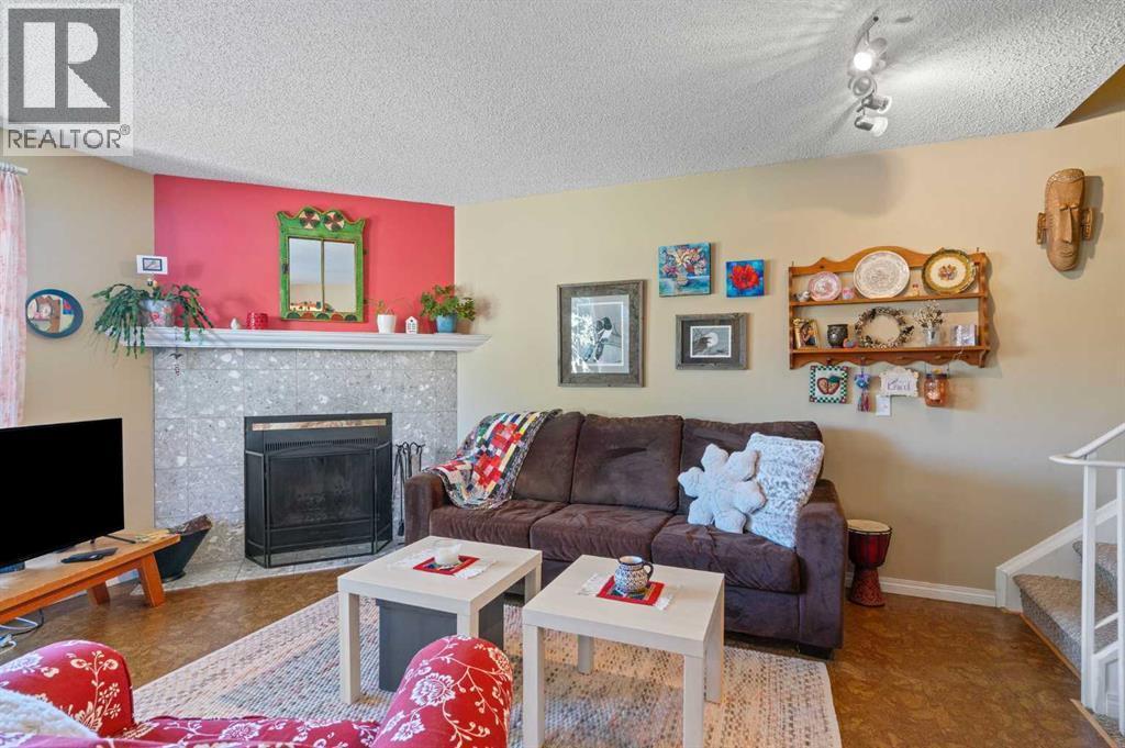 43, 200 Shawnessy Drive Sw, Calgary, AB - Indoor Photo Showing Living Room With Fireplace
