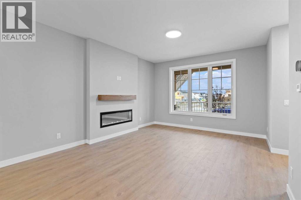 191 Belvedere Crescent Se, Calgary, AB - Indoor Photo Showing Living Room With Fireplace