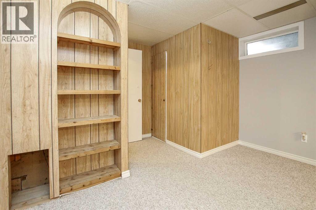 Family Room with Built In's and Storage - 69 Erickson Drive, Red Deer, AB - Indoor Photo Showing Other Room