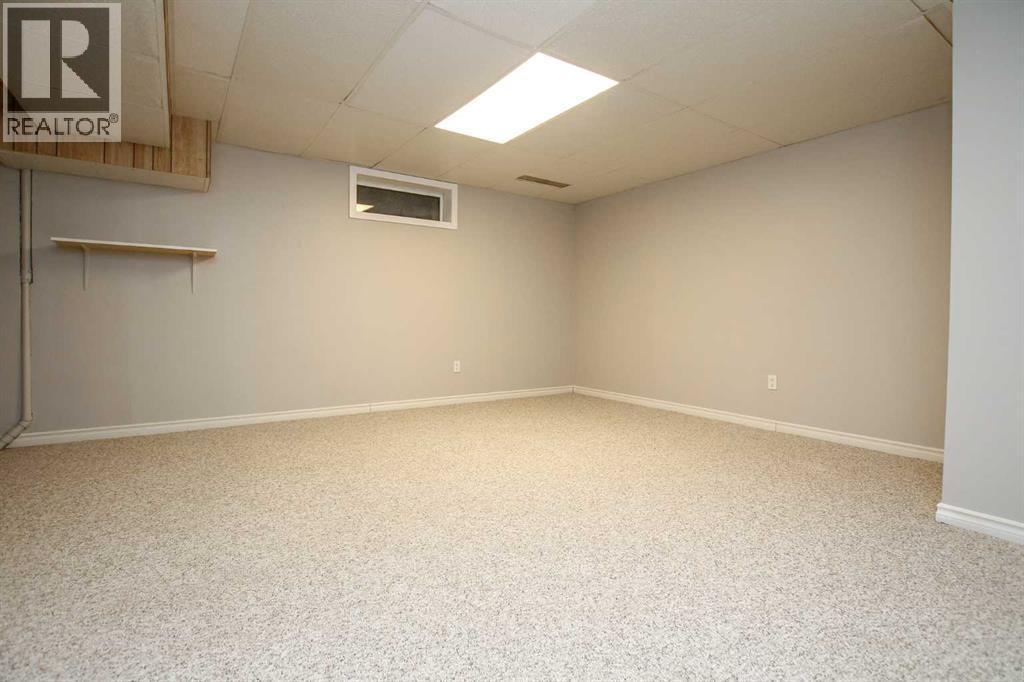 Family Room with Built In's and Storage - 69 Erickson Drive, Red Deer, AB - Indoor Photo Showing Basement