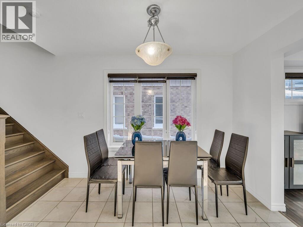 Dining room with light tile patterned floors and stairway - 144 Summit Ridge Drive, Guelph, ON - Indoor Photo Showing Dining Room