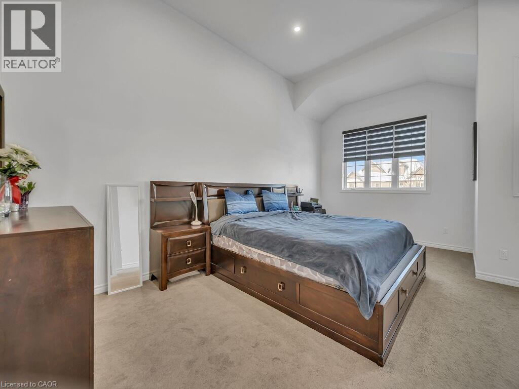 Bedroom featuring lofted ceiling, light colored carpet, and recessed lighting - 144 Summit Ridge Drive, Guelph, ON - Indoor Photo Showing Bedroom