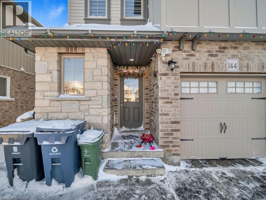 Snow covered property entrance featuring stone siding - 144 Summit Ridge Drive, Guelph, ON - Outdoor