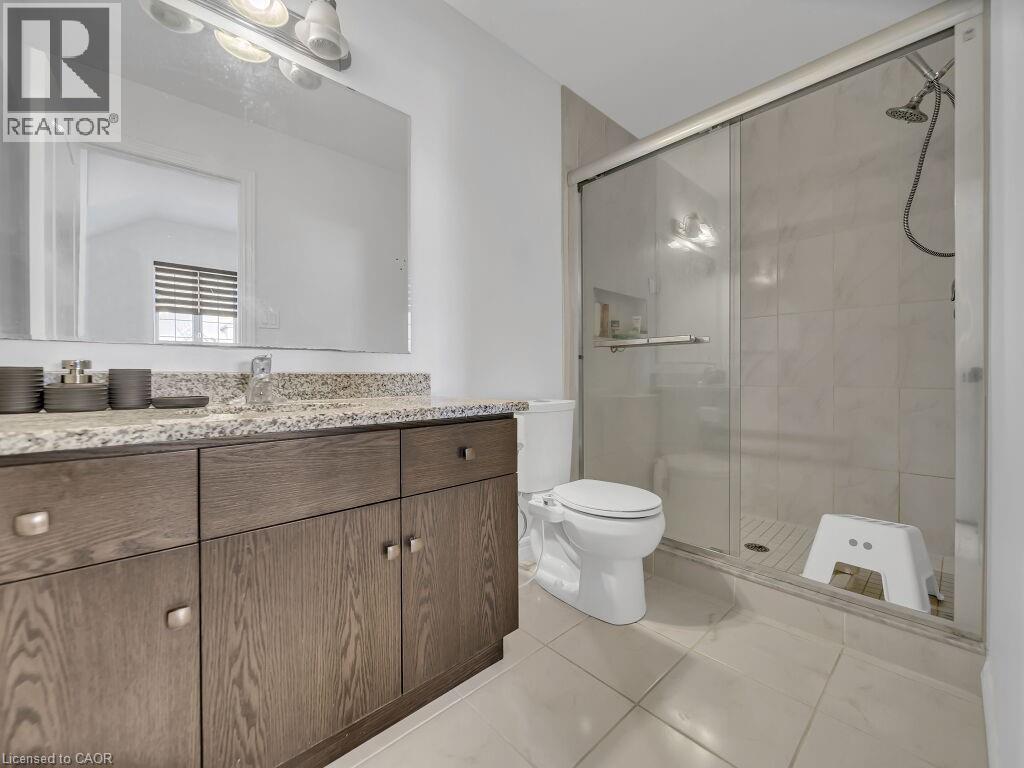 Bathroom with a shower stall, vanity, and light tile patterned flooring - 144 Summit Ridge Drive, Guelph, ON - Indoor Photo Showing Bathroom
