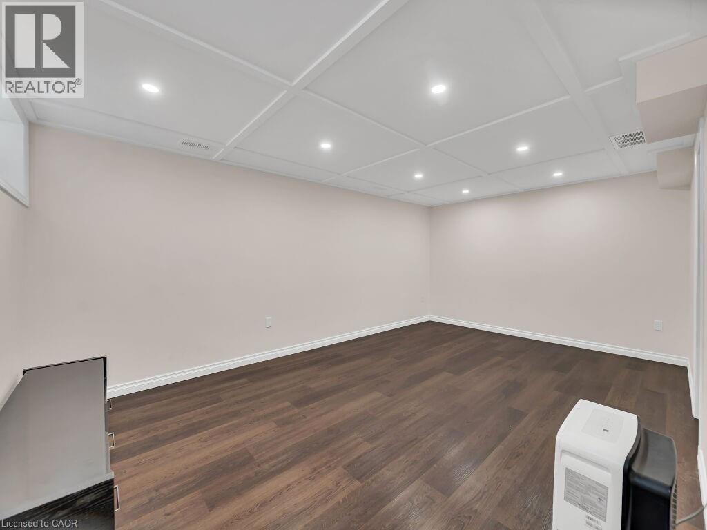 Basement featuring recessed lighting and dark wood-style flooring - 144 Summit Ridge Drive, Guelph, ON - Indoor