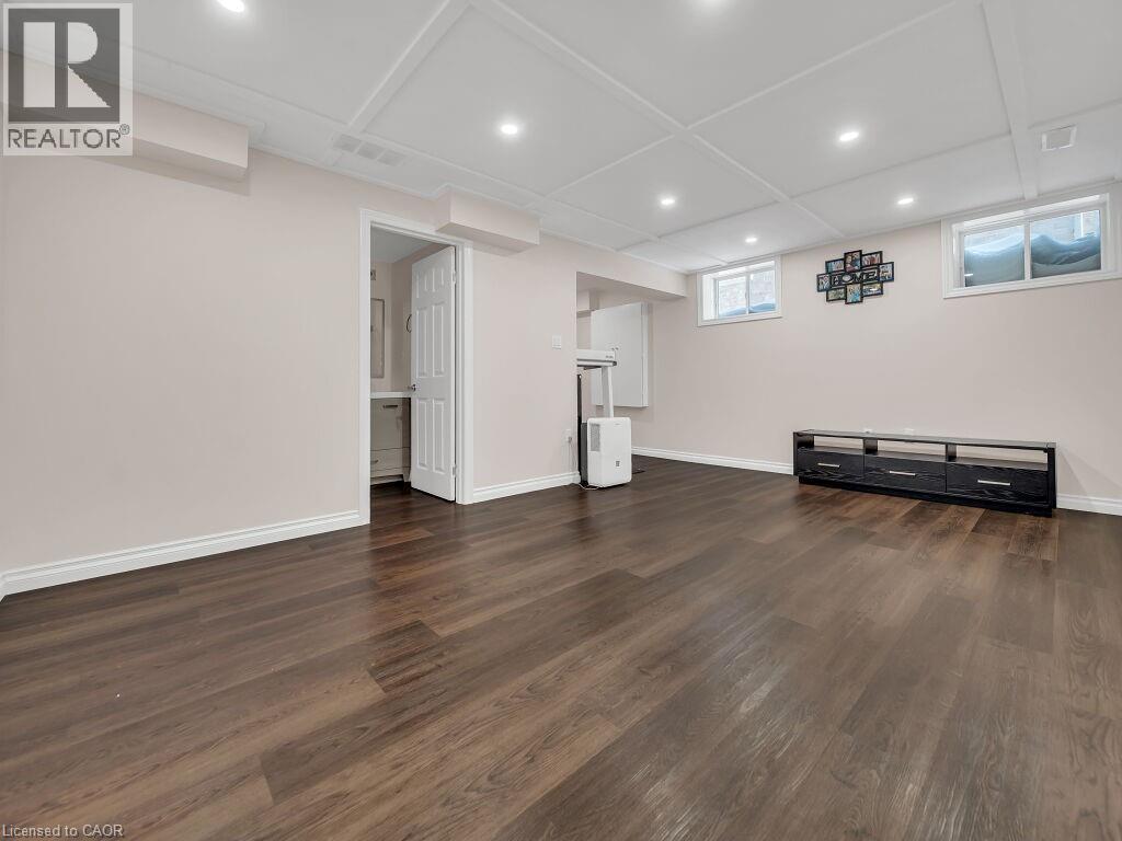 Below grade area featuring dark wood-type flooring and recessed lighting - 144 Summit Ridge Drive, Guelph, ON - Indoor