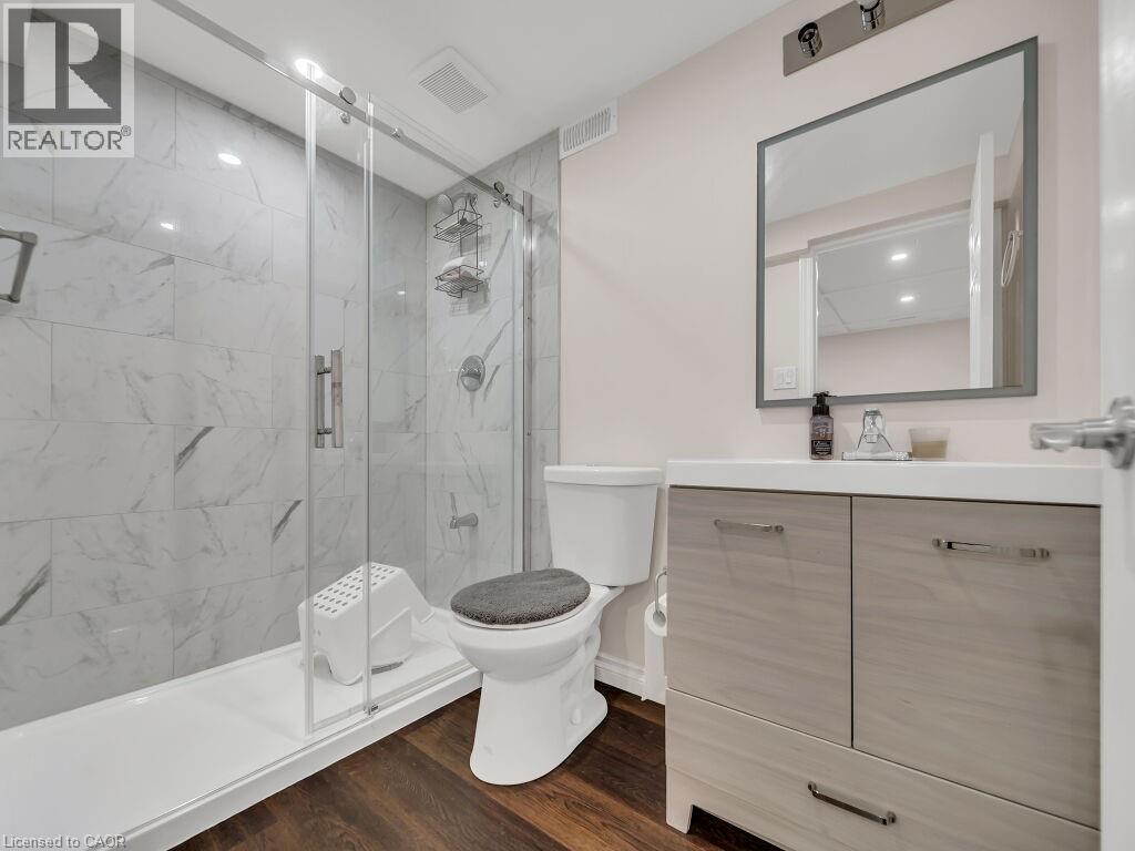 Full bathroom with vanity, a marble finish shower, and dark wood-style floors - 144 Summit Ridge Drive, Guelph, ON - Indoor Photo Showing Bathroom