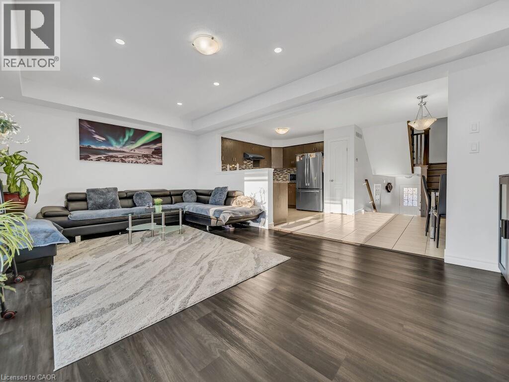 Living area with recessed lighting, wood finished floors, and a tray ceiling - 144 Summit Ridge Drive, Guelph, ON - Indoor Photo Showing Living Room With Fireplace