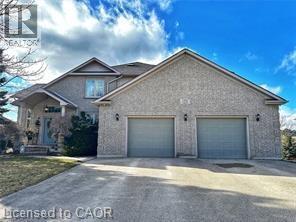 View of front of property featuring driveway and a garage - 158 River Run Road, Drayton, ON - Outdoor With Facade
