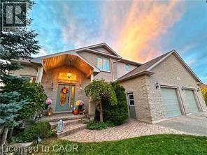 View of front facade with a garage and driveway - 158 River Run Road, Drayton, ON - Outdoor
