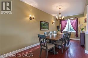 Dining room featuring a chandelier and dark wood-style floors - 158 River Run Road, Drayton, ON - Indoor Photo Showing Dining Room