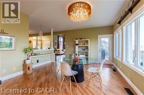 Dining area with a chandelier and wood finished floors - 158 River Run Road, Drayton, ON - Indoor Photo Showing Dining Room