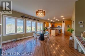 Dining area with a chandelier, dark wood-type flooring, and recessed lighting - 158 River Run Road, Drayton, ON - Indoor