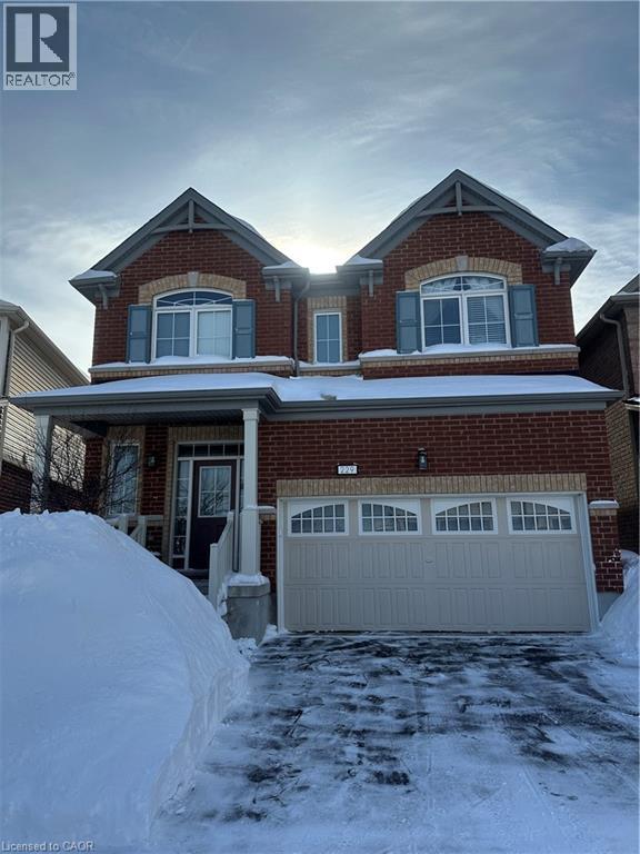 View of front of property with brick siding, covered porch, a garage, and driveway - 229 Pine Glen Crescent, Kitchener, ON - Outdoor
