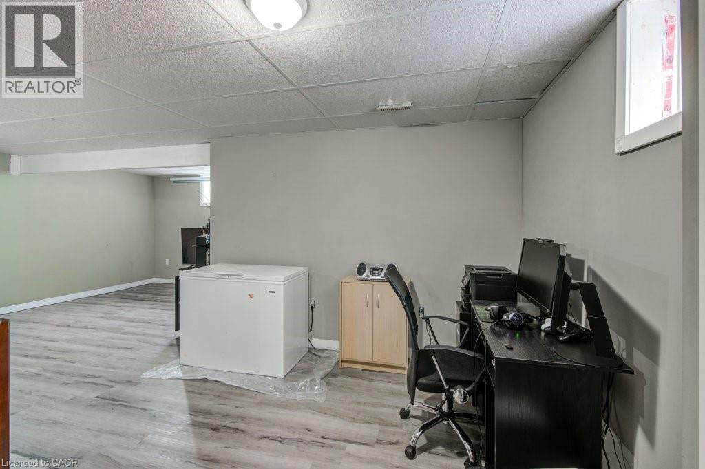Office area with light wood-style floors and a paneled ceiling - 711 Southwood Way, Woodstock, ON - Indoor