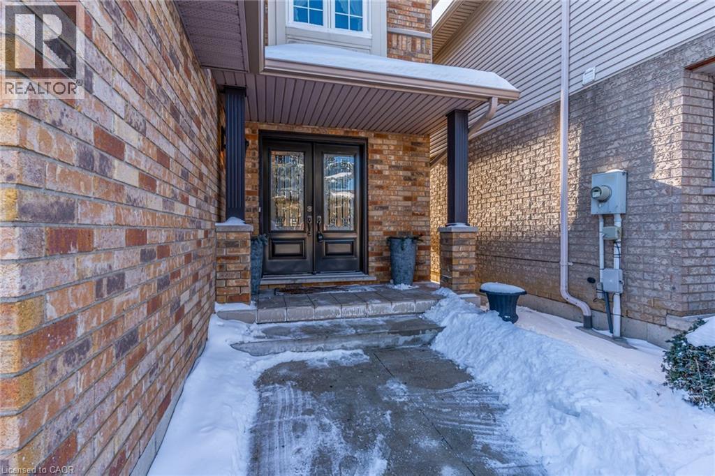 Snow covered property entrance with french doors and brick siding - 15 Claudette Gate, Hamilton, ON - Outdoor