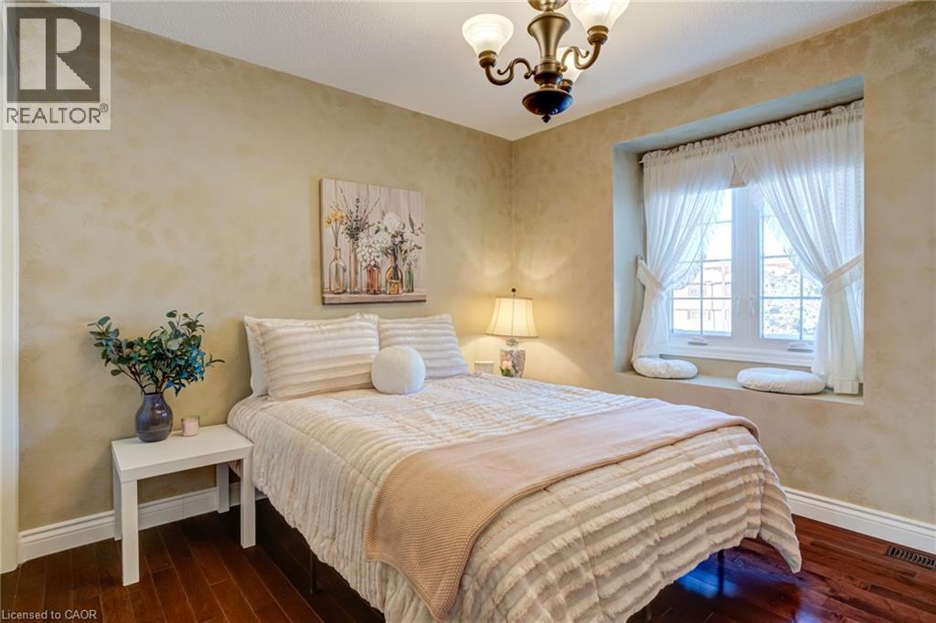 Bedroom featuring dark wood-style floors and a chandelier - 15 Claudette Gate, Hamilton, ON - Indoor Photo Showing Bedroom
