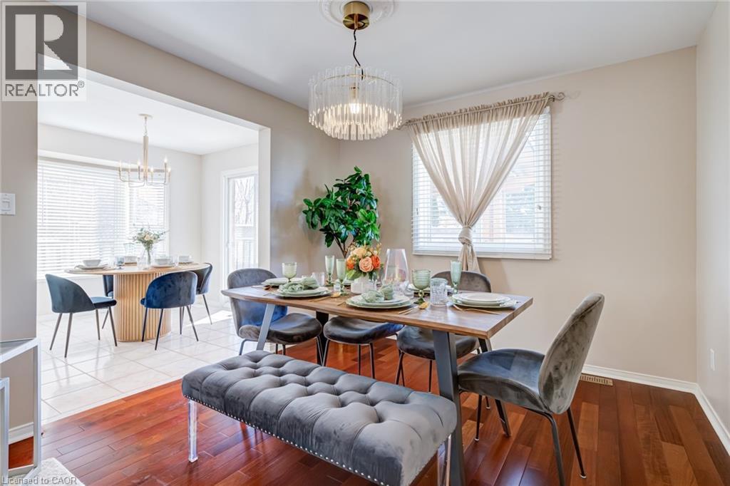 Dining area featuring a chandelier and hardwood / wood-style floors - 15 Claudette Gate, Hamilton, ON - Indoor Photo Showing Dining Room