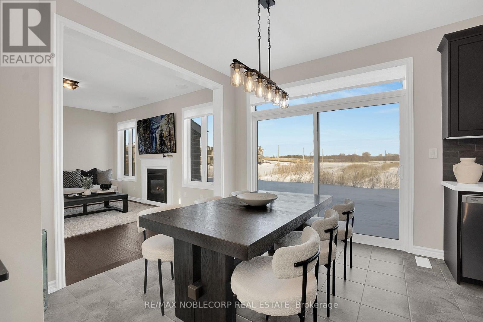 36 Felhazi Trail, Essa, ON - Indoor Photo Showing Dining Room With Fireplace