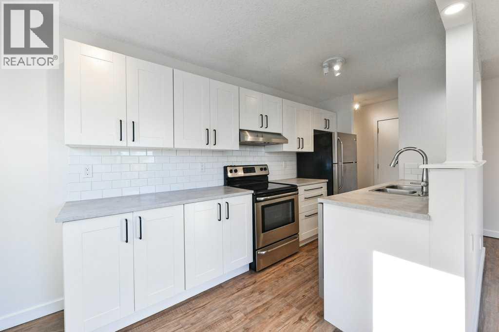204, 2220 16A Street Sw, Calgary, AB - Indoor Photo Showing Kitchen With Stainless Steel Kitchen