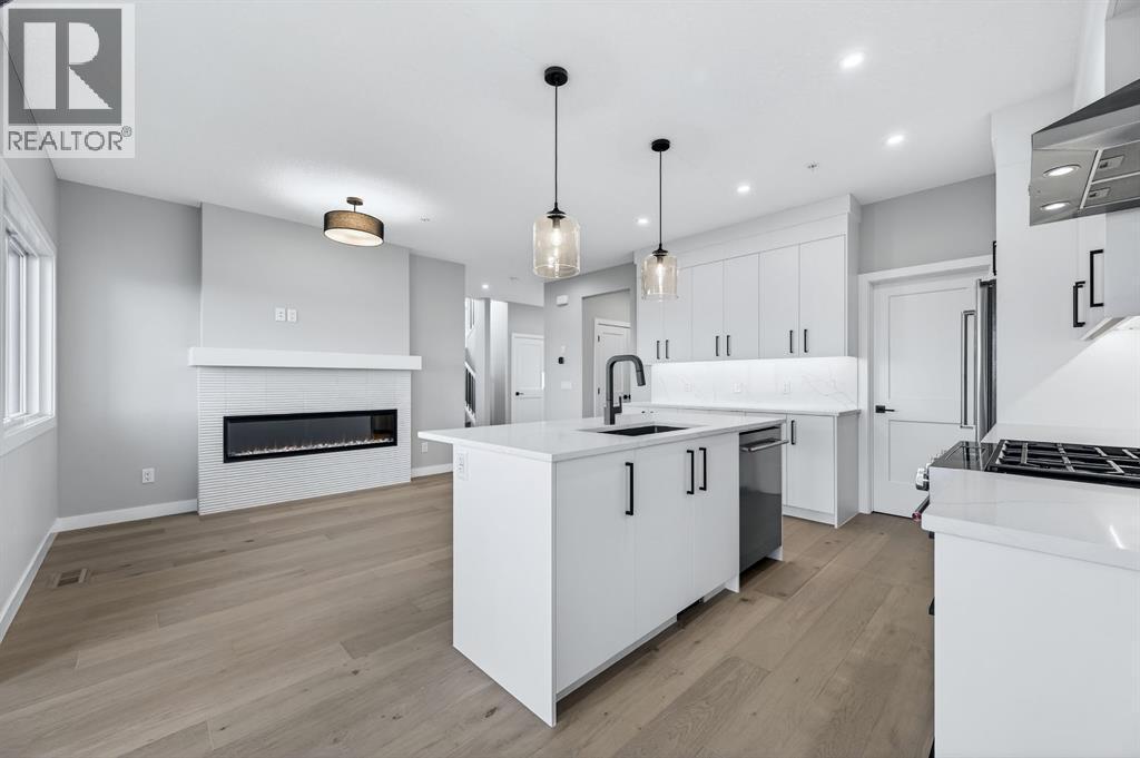 150 Prince Crescent, Rural Rocky View County, AB - Indoor Photo Showing Kitchen With Fireplace With Upgraded Kitchen