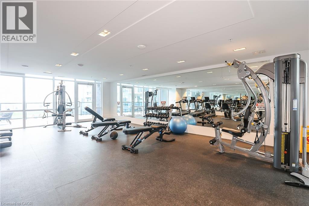 Workout area with expansive windows - 16 Concord Place Unit# 431, Grimsby, ON - Indoor Photo Showing Gym Room