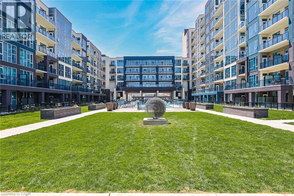 View of community with a yard - 16 Concord Place Unit# 431, Grimsby, ON - Outdoor With Balcony With Facade