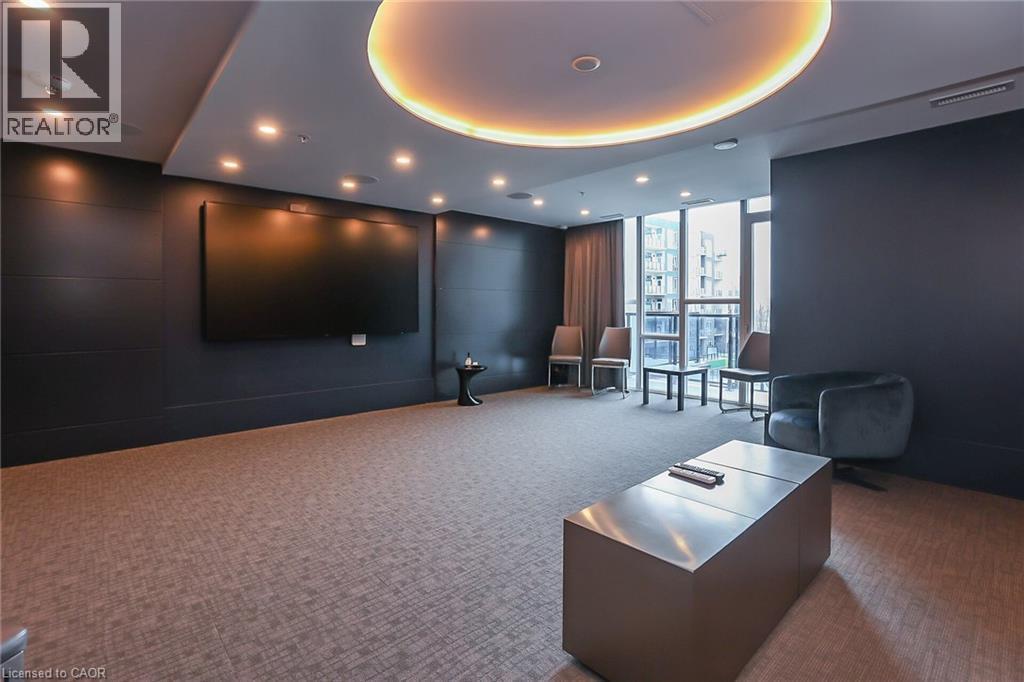 Common area with floor to ceiling windows and recessed lighting - 16 Concord Place Unit# 431, Grimsby, ON - Indoor Photo Showing Other Room