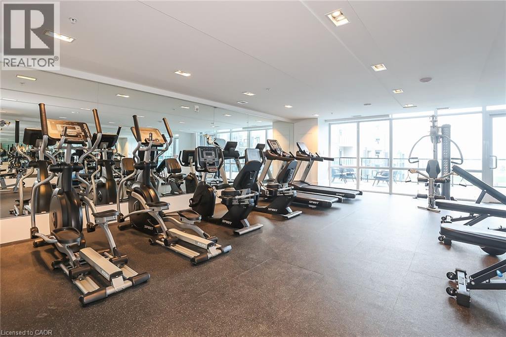 Workout area with floor to ceiling windows - 16 Concord Place Unit# 431, Grimsby, ON - Indoor Photo Showing Gym Room