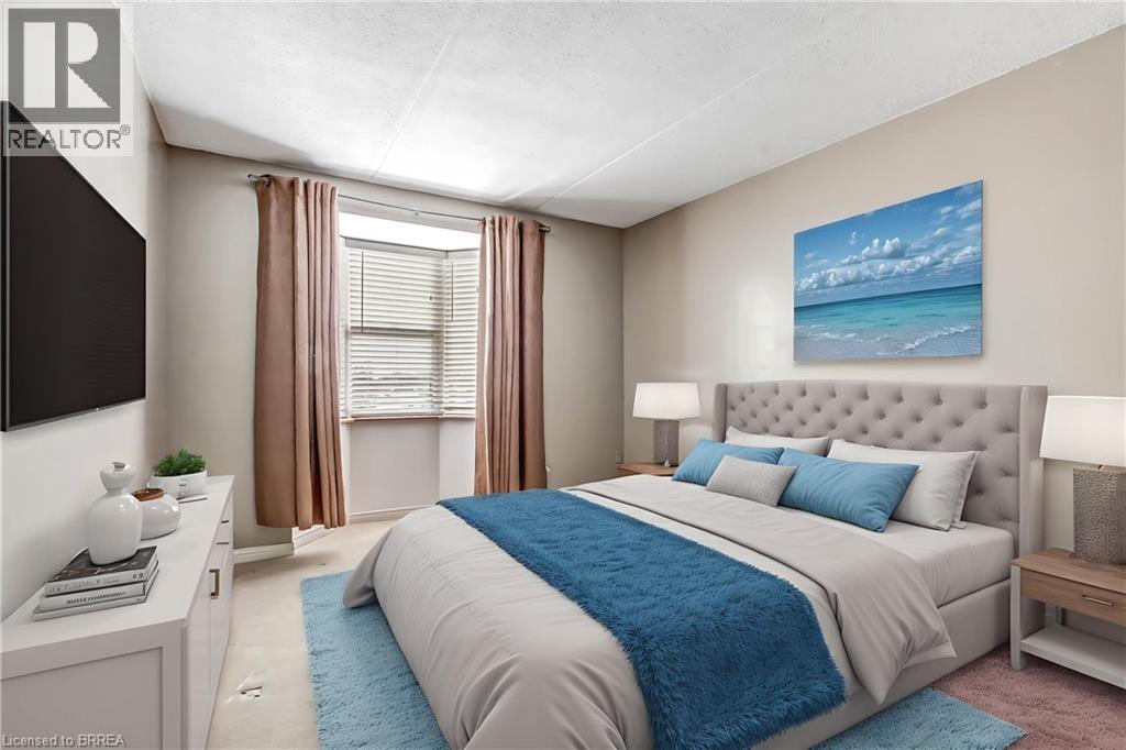 Large primary bedroom with bow window. Virtually staged. - 88 Tollgate Road Unit# 402, Brantford, ON - Indoor Photo Showing Bedroom