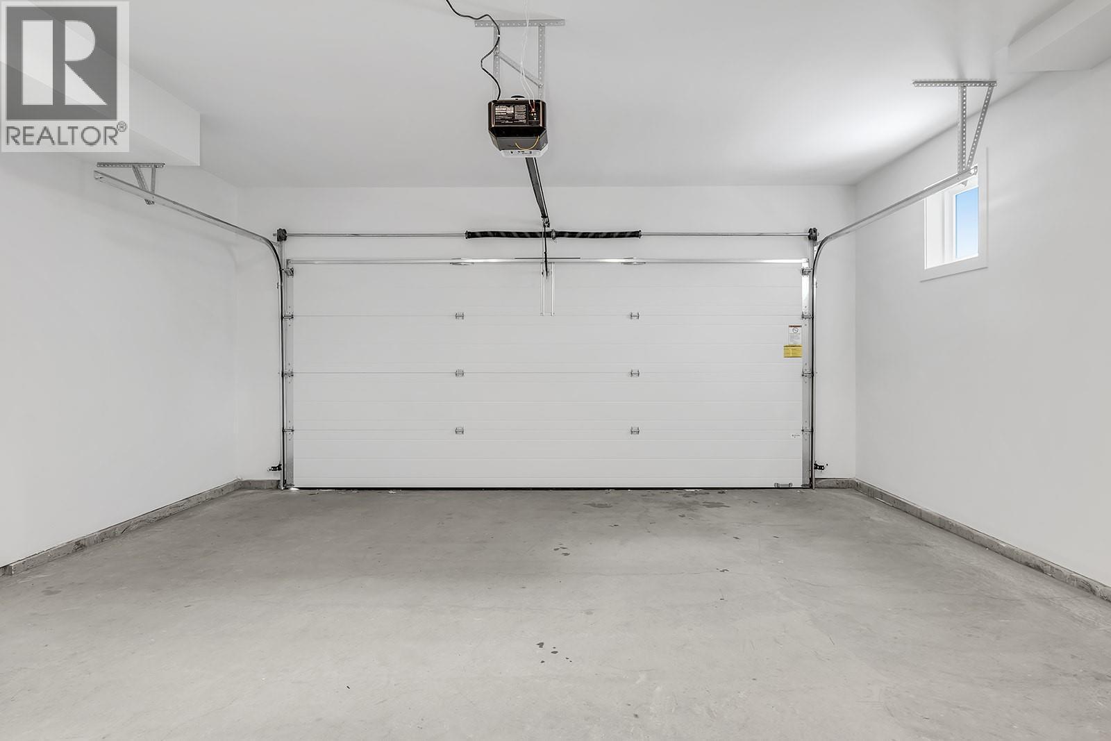 Photos are of a similar home in the community. - 5300 Main Street Unit# 115, Kelowna, BC - Indoor Photo Showing Garage