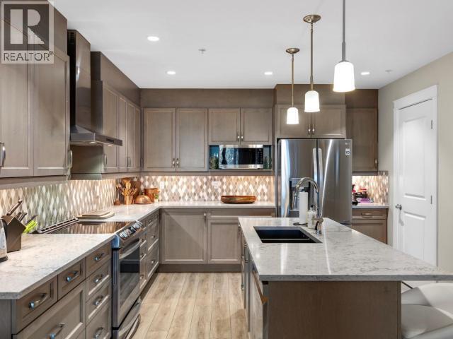 104-36 Waterfront Place, Whitehorse, YT - Indoor Photo Showing Kitchen With Stainless Steel Kitchen With Double Sink With Upgraded Kitchen