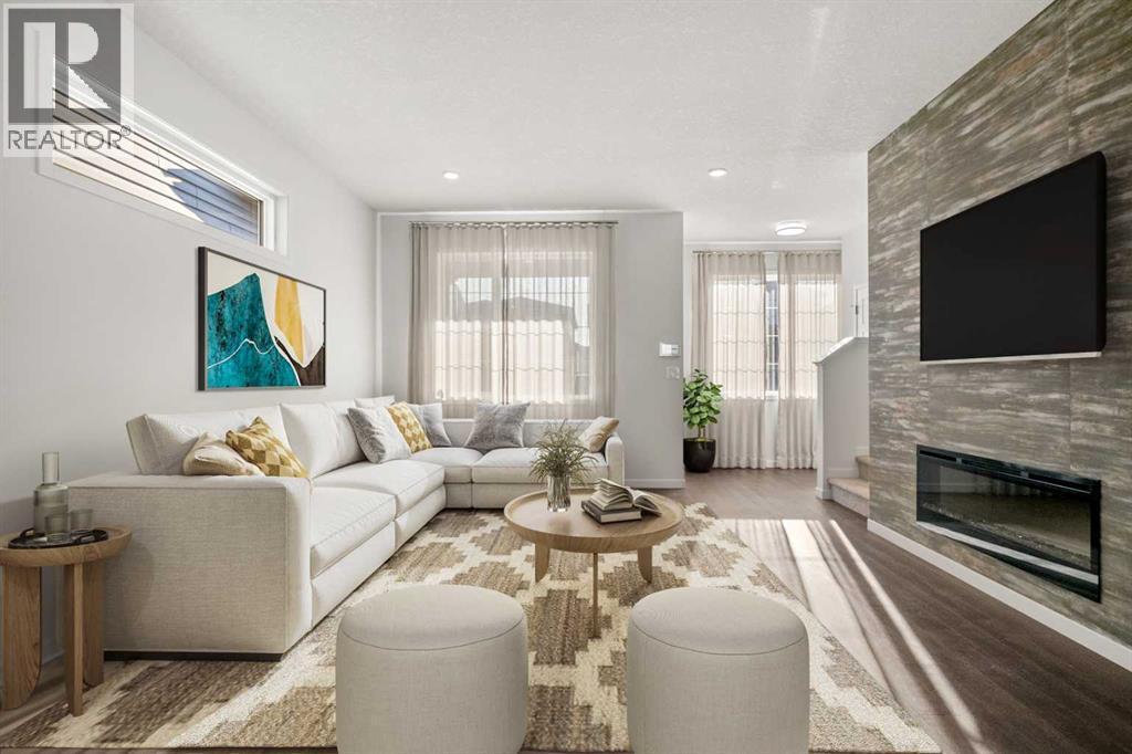 This photo has been virtually staged - 110 Wolf Creek Rise Se, Calgary, AB - Indoor Photo Showing Living Room With Fireplace