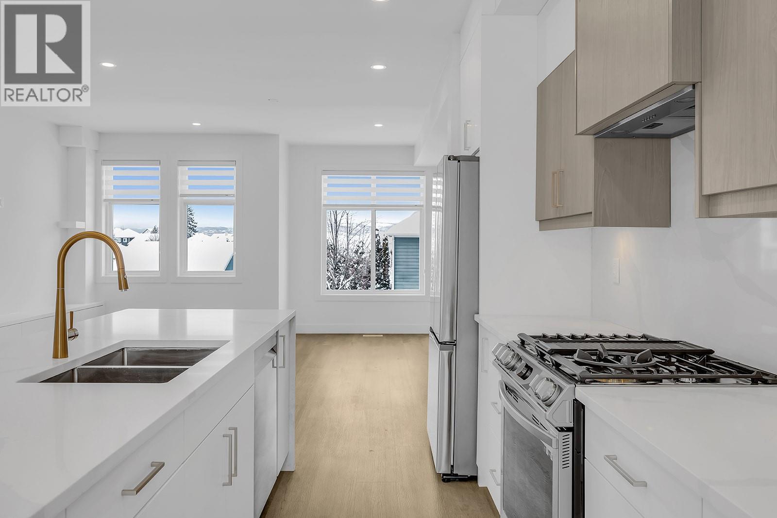 Welcome to #103 at Parallel 4! Photo of a similar home in the community. - 5300 Main Street Unit# 103, Kelowna, BC - Indoor Photo Showing Kitchen With Double Sink With Upgraded Kitchen