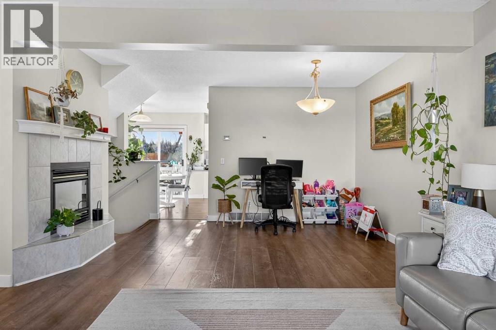 41 Sandarac Villas Nw, Calgary, AB - Indoor Photo Showing Living Room With Fireplace