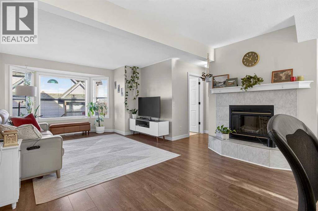 41 Sandarac Villas Nw, Calgary, AB - Indoor Photo Showing Living Room With Fireplace