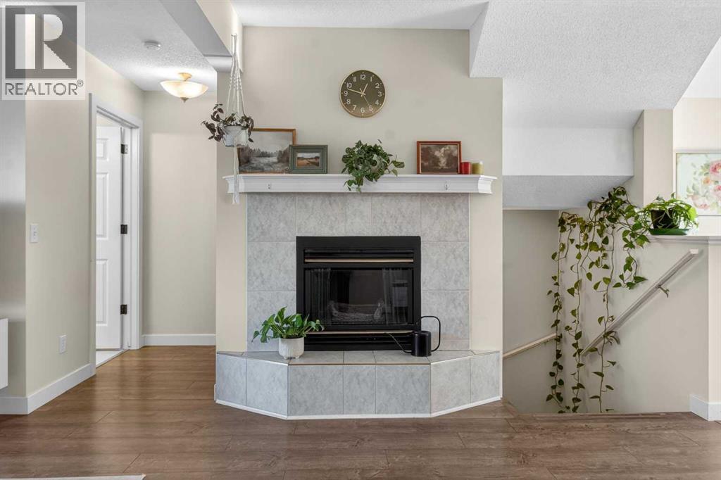 41 Sandarac Villas Nw, Calgary, AB - Indoor Photo Showing Living Room With Fireplace